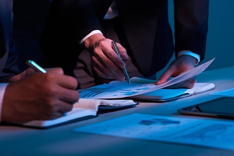People in business suits signing documents - Mexico's Tax Revenue Service Case Study